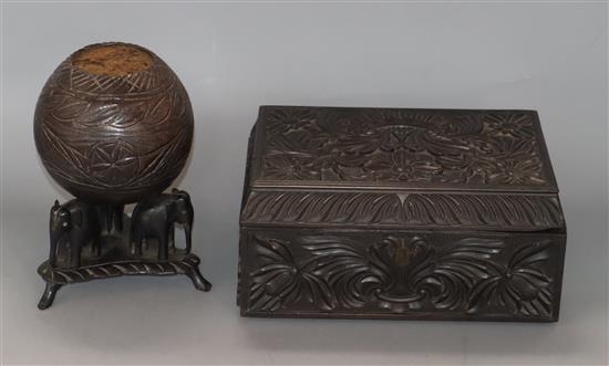 A Ceylonese carved ebony box and a coconut shell and elephant stand